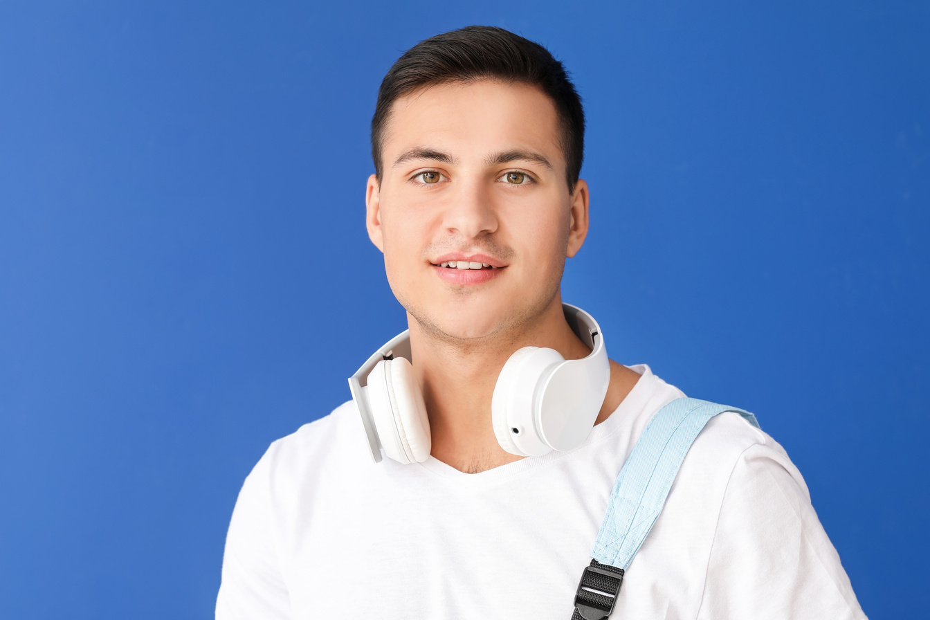 Portrait of Male Student on Blue Background